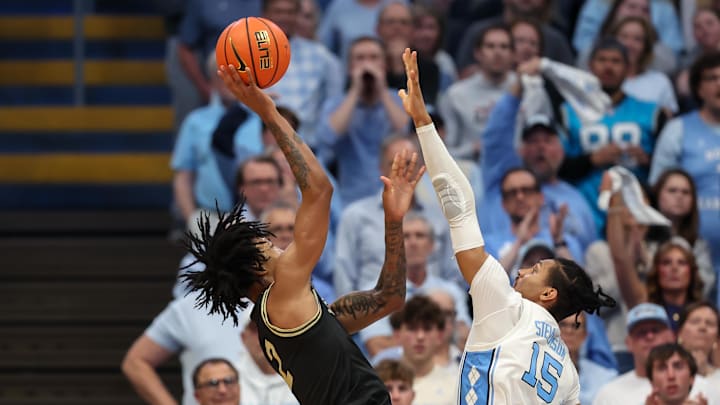 Jan 10, 2026; Chapel Hill, North Carolina, USA; Wake Forest Demon Deacons forward Juke Harris (2) attempts a basket with North Carolina Tar Heels forward Jarin Stevenson (15) defending during the second half at Dean E. Smith Center. Mandatory Credit: Cory Knowlton-Imagn Images