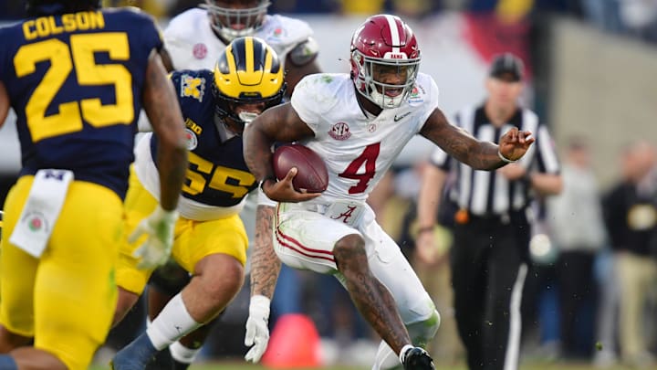 Jan 1, 2024; Pasadena, CA, USA; Alabama Crimson Tide quarterback Jalen Milroe (4) runs against Michigan Wolverines defensive lineman Mason Graham (55) in the third quarter in the 2024 Rose Bowl college football playoff semifinal game at Rose Bowl