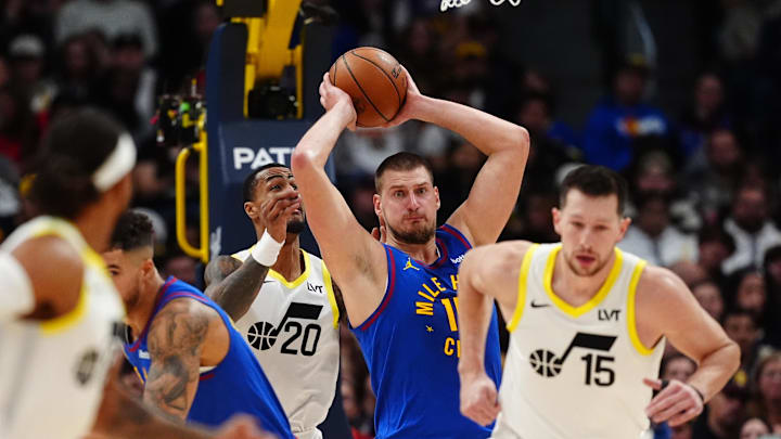 Nov 2, 2024; Denver, Colorado, USA; Utah Jazz forward John Collins (20) and Denver Nuggets center Nikola Jokic (15) under the basket in the the third quarter at Ball Arena. Mandatory Credit: Ron Chenoy-Imagn Images