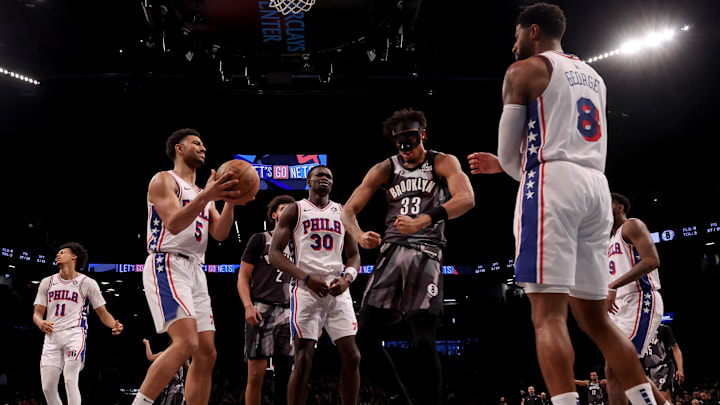 Feb 12, 2025; Brooklyn, New York, USA; Brooklyn Nets center Nic Claxton (33) reacts after a basket against Philadelphia 76ers guard Quentin Grimes (5) and center Adem Bona (30) and forward Paul George (8) during the third quarter at Barclays Center. Mandatory Credit: Brad Penner-Imagn Images Feb 12, 2025; Brooklyn, New York, USA; Brooklyn Nets center Nic Claxton (33) reacts after a basket against Philadelphia 76ers guard Quentin Grimes (5) and center Adem Bona (30) and forward Paul George (8) during the third quarter at Barclays Center. Mandatory Credit: Brad Penner-Imagn Images