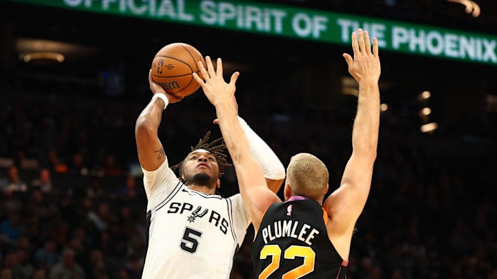 Dec 3, 2024; Phoenix, Arizona, USA; San Antonio Spurs guard Stephon Castle (5) shoots the ball against Phoenix Suns center Mason Plumlee (22) in the first half of an NBA Cup game at Footprint Center. Mandatory Credit: Mark J. Rebilas-Imagn Images