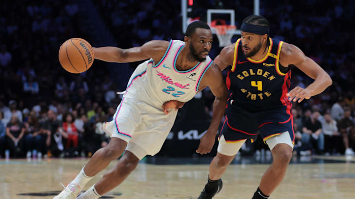 Mar 25, 2025; Miami, Florida, USA; Miami Heat forward Andrew Wiggins (22) drives to the basket against Golden State Warriors guard Moses Moody (4) during the third quarter at Kaseya Center. Mandatory Credit: Sam Navarro-Imagn Images