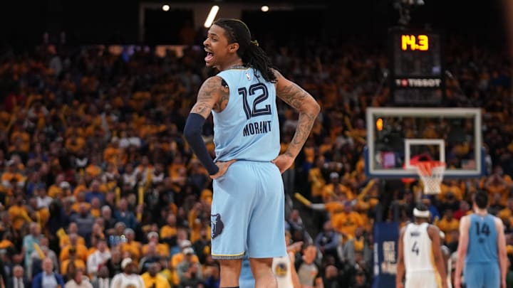 Apr 15, 2025; San Francisco, California, USA; Memphis Grizzlies guard Ja Morant (12) interacts with players from the Golden State Warriors team bench in the fourth quarter at the Chase Center. Mandatory Credit: Cary Edmondson-Imagn Images