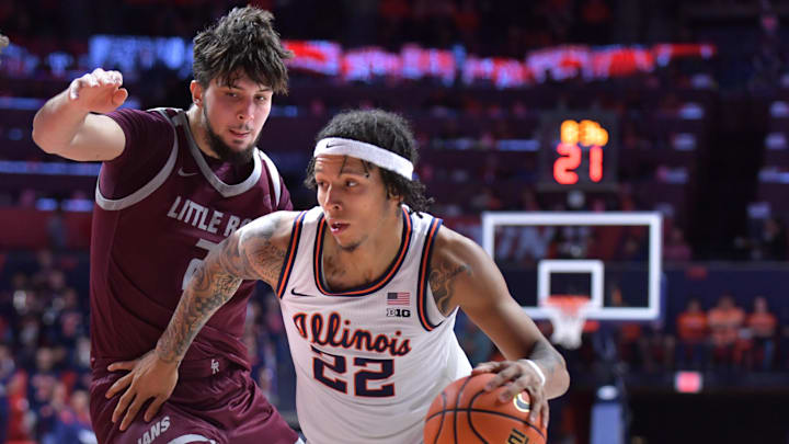 Nov 25, 2024; Champaign, Illinois, USA;  Illinois Fighting Illini guard Tre White (22) drives the ball past Little Rock Trojans forward Ante Beljan (21) during the first half at State Farm Center. Mandatory Credit: Ron Johnson-Imagn Images