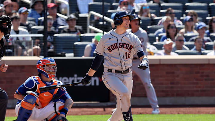 Former Houston Astros catcher Jason Castro watches the ball wearing a gray jersey and navy blue helmet.