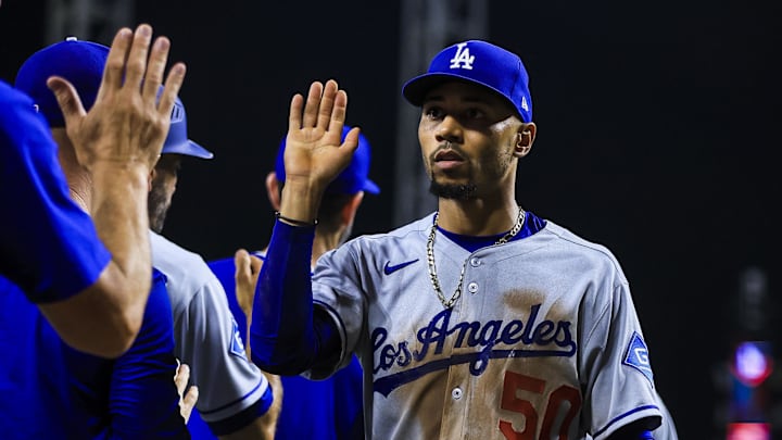 Los Angeles Dodgers shortstop Mookie Betts (50) high fives teammates after the victory over the Cincinnati Reds at Great American Ball Park on July 28.