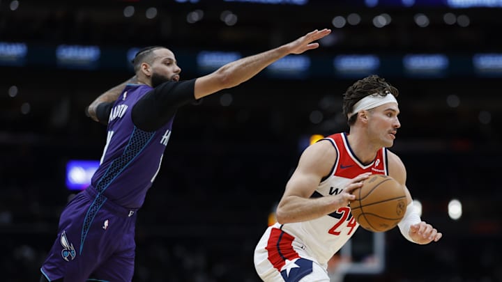 Dec 19, 2024; Washington, District of Columbia, USA; Washington Wizards forward Corey Kispert (24) drives to the basket past Charlotte Hornets forward Cody Martin (11) in the third quarter at Capital One Arena. Mandatory Credit: Geoff Burke-Imagn Images
