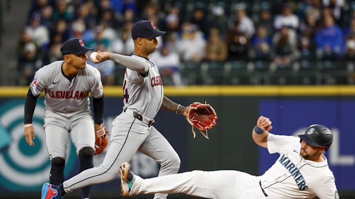 Apr 2, 2024; Seattle, Washington, USA; Cleveland Guardians shortstop Brayan Rocchio (4) turns a double play against Seattle Mariners catcher Cal Raleigh (29) during the second inning at T-Mobile Park. Mandatory Credit: Joe Nicholson-USA TODAY Sports Apr 2, 2024; Seattle, Washington, USA; Cleveland Guardians shortstop Brayan Rocchio (4) turns a double play against Seattle Mariners catcher Cal Raleigh (29) during the second inning at T-Mobile Park. Mandatory Credit: Joe Nicholson-USA TODAY Sports