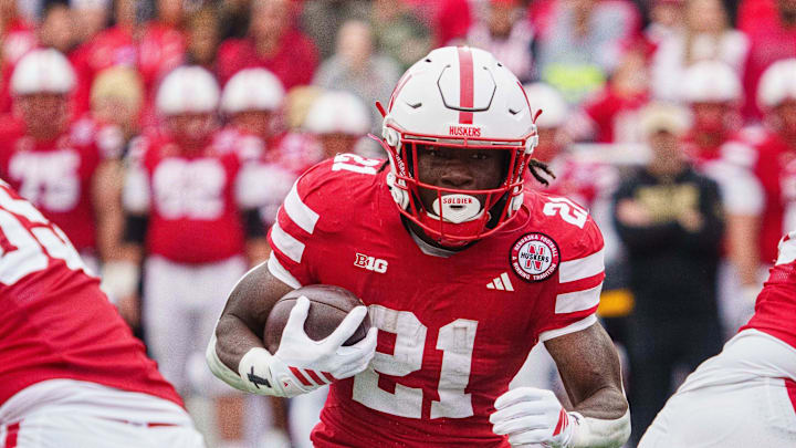 Oct 25, 2025; Lincoln, Nebraska, USA; Nebraska Cornhuskers running back Emmett Johnson (21) runs the ball against the Northwestern Wildcats during the first quarter at Memorial Stadium. Mandatory Credit: Dylan Widger-Imagn Images