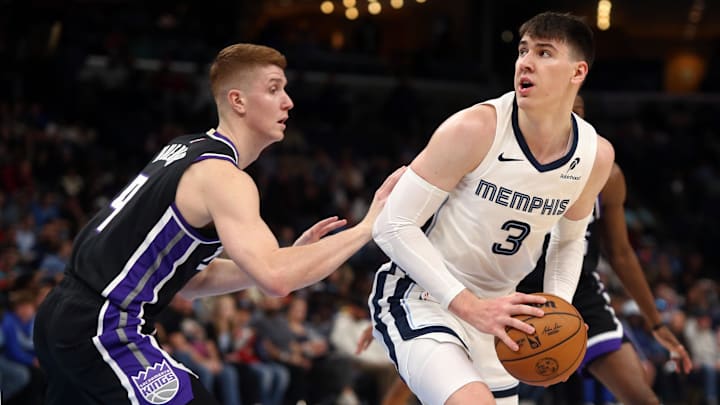 Dec 5, 2024; Memphis, Tennessee, USA; Memphis Grizzlies forward Jake LaRavia (3) spins away from Sacramento Kings guard Kevin Huerter (9) during the second quarter at FedExForum. Mandatory Credit: Petre Thomas-Imagn Images