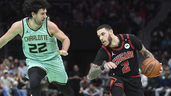 Dec 30, 2024; Charlotte, North Carolina, USA;  Chicago Bulls guard Lonzo Ball (2) moves the ball against Charlotte Hornets guard vasa Micic (22) during the second half at the Spectrum Center. Mandatory Credit: Sam Sharpe-Imagn Images