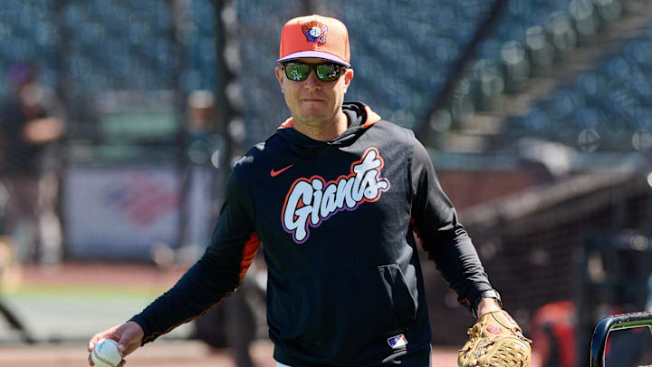 May 20, 2025; San Francisco, California, USA; San Francisco Giants first base coach Mark Hallberg (91) warms up on the field before the game between the San Francisco Giants and the Kansas City Royals at Oracle Park. Mandatory Credit: Robert Edwards-Imagn Images