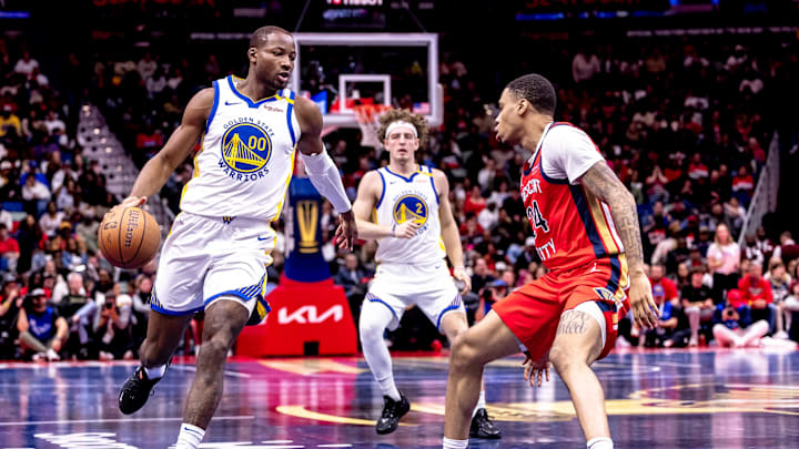 Nov 22, 2024; New Orleans, Louisiana, USA;  Golden State Warriors forward Jonathan Kuminga (00) brings the ball up court against New Orleans Pelicans guard Jordan Hawkins (24) during second half at Smoothie King Center. Mandatory Credit: Stephen Lew-Imagn Images