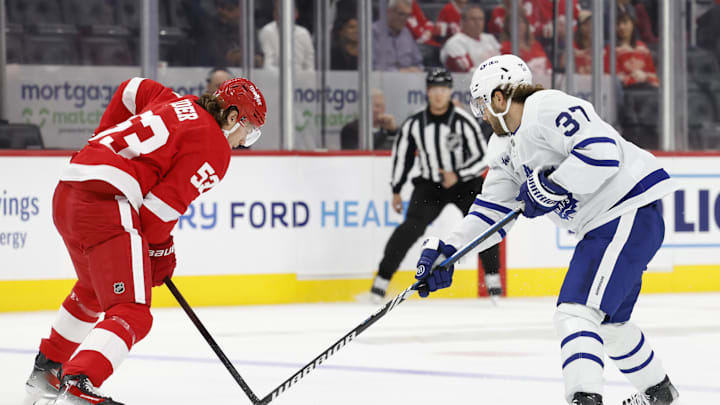 Oct 3, 2024; Detroit, Michigan, USA;  Detroit Red Wings defenseman Moritz Seider (53) and Toronto Maple Leafs defenseman Timothy Liljegren (37) battle for the puck in the first period at Little Caesars Arena. Mandatory Credit: Rick Osentoski-Imagn Images