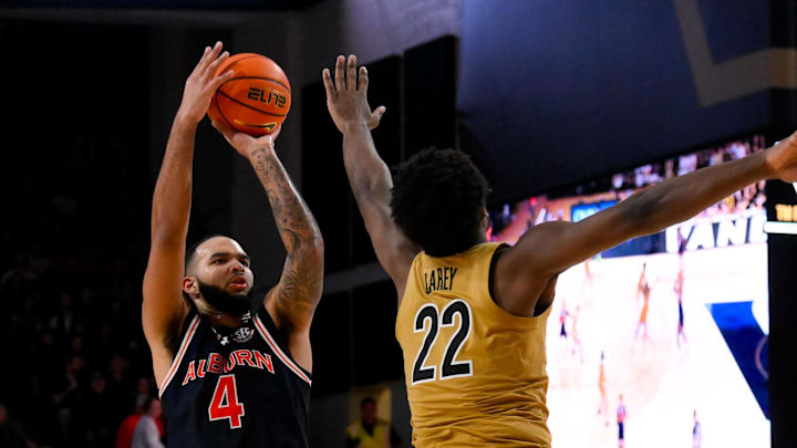 Feb 11, 2025; Nashville, Tennessee, USA; Auburn Tigers forward Johni Broome (4) shoots over  Vanderbilt Commodores forward Jaylen Carey (22) during the second half at Memorial Gymnasium. Mandatory Credit: Steve Roberts-Imagn Images