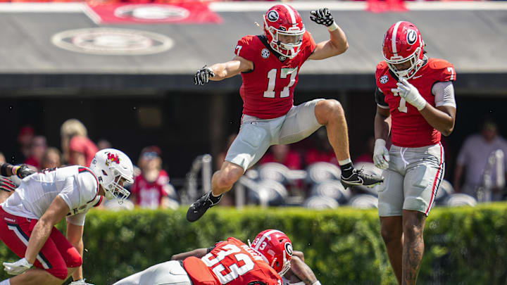 Sep 9, 2023; Athens, Georgia, USA; Georgia Bulldogs defensive back Dan Jackson (17) jumps over players after a play against the Ball State Cardinals during the second half at Sanford Stadium. Mandatory Credit: Dale Zanine-Imagn Images