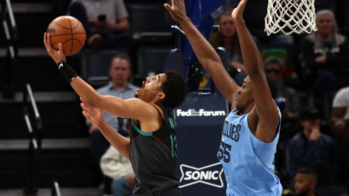 Mar 12, 2024; Memphis, Tennessee, USA; Washington Wizards guard Jordan Poole (13) shoots as Memphis Grizzlies center Trey Jemison (55) defends during the second half at FedExForum. Mandatory Credit: Petre Thomas-Imagn Images
