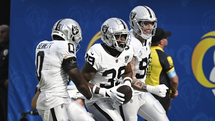 Oct 20, 2024; Inglewood, California, USA; Las Vegas Raiders cornerback Nate Hobbs (39) celebrates intercepting a Los Angeles Rams quarterback Matthew Stafford (not pictured) pass during the third quarter at SoFi Stadium. Left is Las Vegas Raiders cornerback Jakorian Bennett (0), right is defensive end Maxx Crosby (98). Mandatory Credit: Robert Hanashiro-Imagn Images