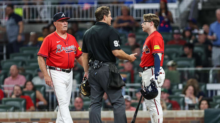 Aug 22, 2025; Cumberland, Georgia, USA; Atlanta Braves shortstop Nick Allen (2) and Atlanta Braves manager Brian Snitker (43) speak to the umpire in the game against the New York Mets during the fifth inning at Truist Park. Mandatory Credit: Jordan Godfree-Imagn Images