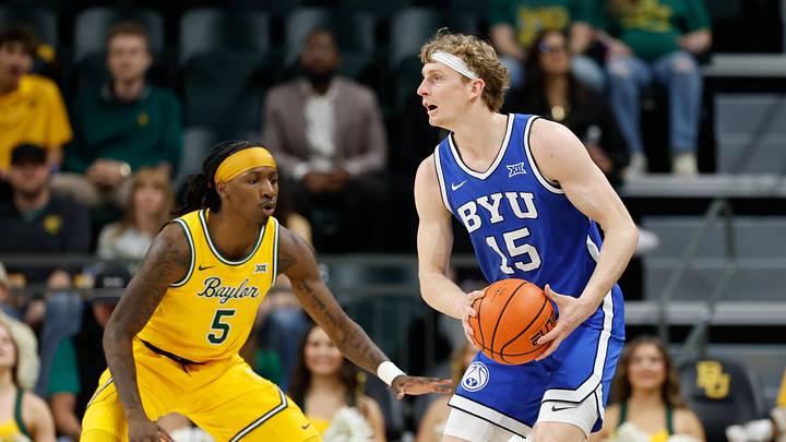 Feb 10, 2026; Waco, Texas, USA; BYU Cougars guard Richie Saunders (15) looks to pass against Baylor Bears guard Obi Agbim (5) during the first half at Paul and Alejandra Foster Pavilion. Mandatory Credit: Chris Jones-Imagn Images