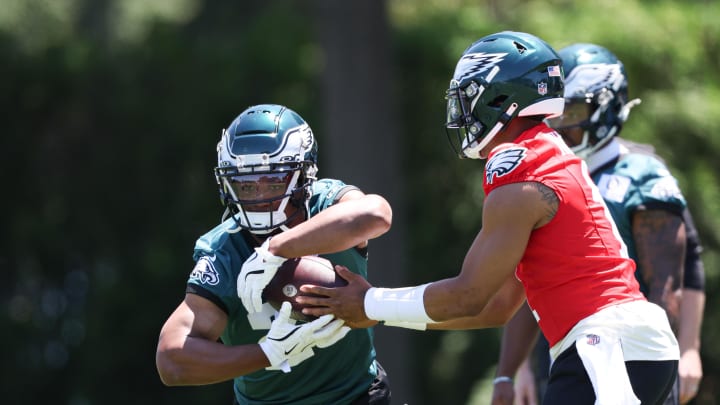 May 30, 2024; Philadelphia, PA, USA; Philadelphia Eagles quarterback Jalen Hurts (1) hands off to running back Saquon Barkley (26) during practice at NovaCare Complex. May 30, 2024; Philadelphia, PA, USA; Philadelphia Eagles quarterback Jalen Hurts (1) hands off to running back Saquon Barkley (26) during practice at NovaCare Complex.