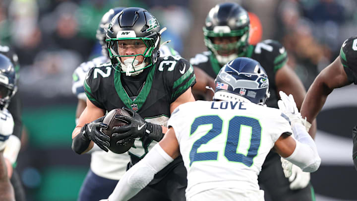 Dec 1, 2024; East Rutherford, New Jersey, USA; New York Jets running back Isaiah Davis (32) gains yards after catch as Seattle Seahawks safety Julian Love (20) pursues during the second half at MetLife Stadium.