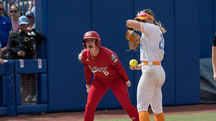 May 30, 2026; Oklahoma City, OK, USA;  Texas Tech Red Raiders third baseman Taylor Pannell (6) yells towards her dugout after a stolen base as Tennessee Lady Volunteers infielder Ella Dodge (25) looks on in the seventh inning during the NCAA Women’s College World Series at Devon Park. Mandatory Credit: Brett Rojo-Imagn Images