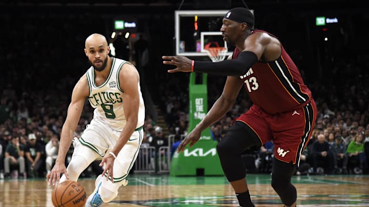 Apr 21, 2024; Boston, Massachusetts, USA; Boston Celtics guard Derrick White (9) controls the ball against Miami Heat center Bam Adebayo - Bob DeChiara/USA TODAY Sports
