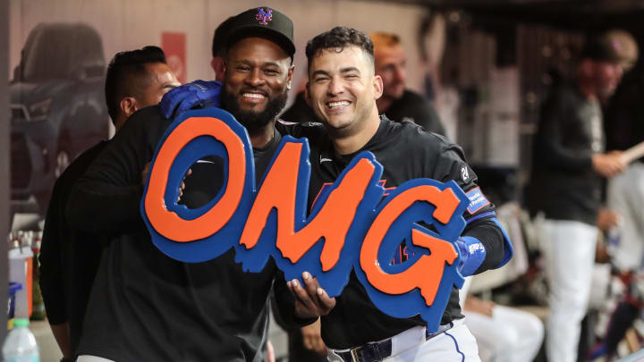 Jul 12, 2024; New York City, New York, USA; New York Mets second baseman Jose Iglesias (11) celebrates in the dugout with pitcher Luis Severino (40) after hitting a solo home run in the second inning against the Colorado Rockies at Citi Field.