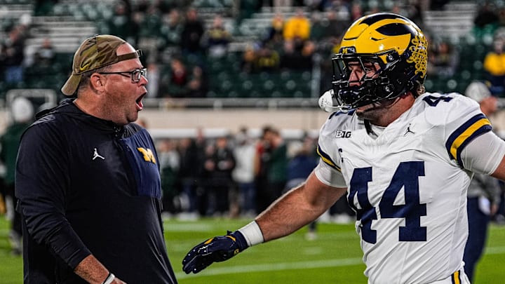 Michigan tight end Max Bredeson shakes hands with tight ends coach Steve Casula during warmups at Spartan Stadium in East Lansing on Saturday, October 25, 2025. Michigan tight end Max Bredeson shakes hands with tight ends coach Steve Casula during warmups at Spartan Stadium in East Lansing on Saturday, October 25, 2025.