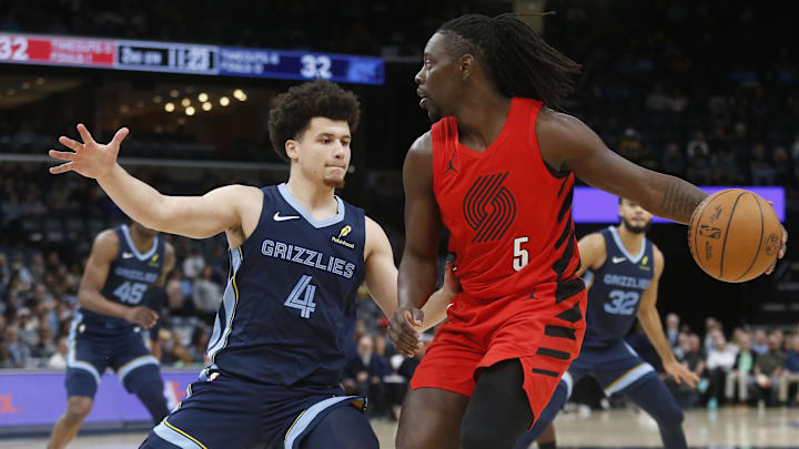 Mar 4, 2026; Memphis, Tennessee, USA; Portland Trail Blazers guard Jrue Holiday (5) dribbles as Memphis Grizzlies guard Walter Clayton Jr. (4) defends during the second quarter at FedExForum. Mandatory Credit: Petre Thomas-Imagn Images