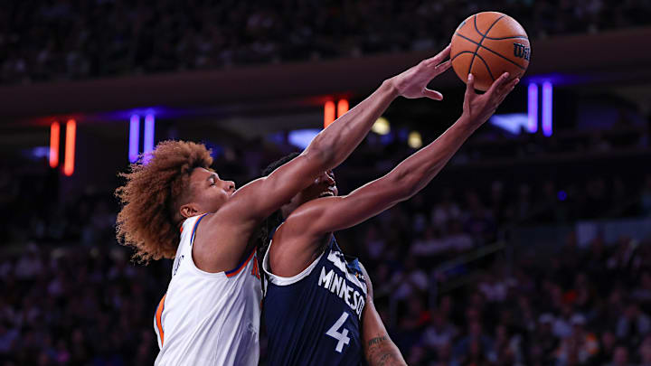 Oct 13, 2024; New York, New York, USA; New York Knicks guard Miles McBride (2) blocks a shot by Minnesota Timberwolves guard Rob Dillingham (4) during the second half at Madison Square Garden. Mandatory Credit: Vincent Carchietta-Imagn Images
