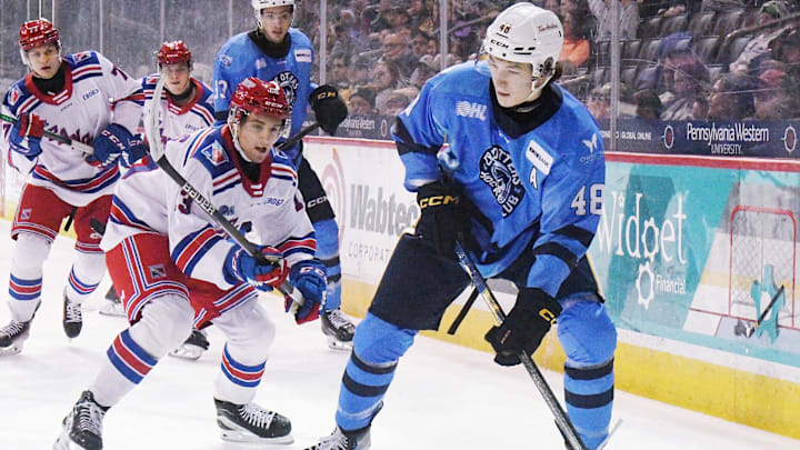 Erie Otters defenseman Matthew Schaefer, right, controls the puck against the Kitchener Rangers at Erie Insurance Arena in Erie on Nov. 23, 2024.