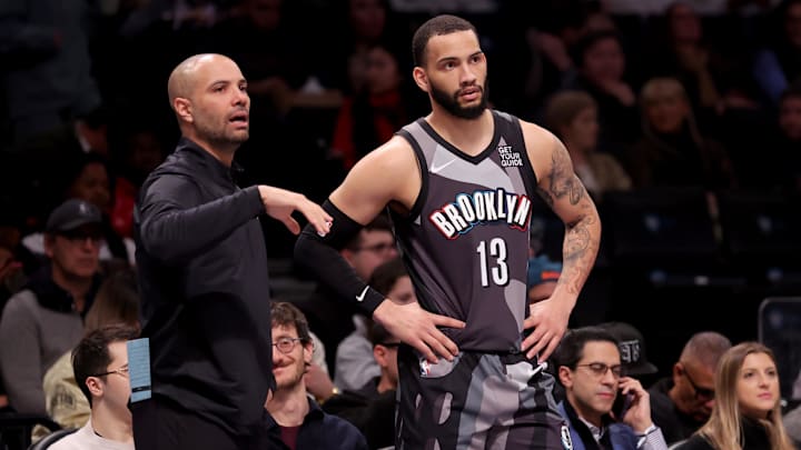 Feb 12, 2025; Brooklyn, New York, USA; Brooklyn Nets head coach Jordi Fernandez talks to guard Tyrese Martin (13) during the first quarter against the Philadelphia 76ers at Barclays Center. Mandatory Credit: Brad Penner-Imagn Images