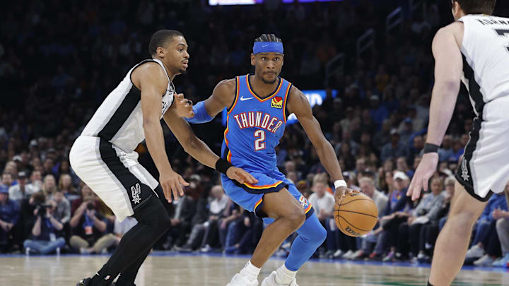 Jan 13, 2026; Oklahoma City, Oklahoma, USA; Oklahoma City Thunder guard Shai Gilgeous-Alexander (2) drives down the court past San Antonio Spurs forward/guard Keldon Johnson (3) during the second half at Paycom Center. Mandatory Credit: Alonzo Adams-Imagn Images