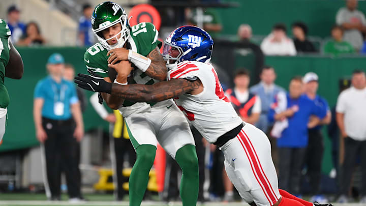 Aug 24, 2024; East Rutherford, New Jersey, USA; New York Giants linebacker Tomon Fox (45) sacks New York Jets quarterback Adrain Martinez (15) during the first half at MetLife Stadium.  