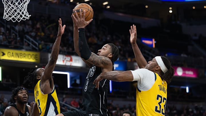 Mar 20, 2025; Indianapolis, Indiana, USA; Brooklyn Nets forward Trendon Watford (9) shoots the ball while Indiana Pacers center Myles Turner (33) defends in the second half at Gainbridge Fieldhouse. Mandatory Credit: Trevor Ruszkowski-Imagn Images