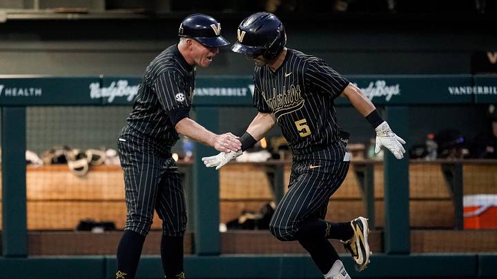 Vanderbilt coach Tim Corbin congratulates second baseman Mike Mancini (5) on his home run against Oklahoma during the sixth inning at Hawkins Field in Nashville, Tenn., Thursday, April 9, 2026.