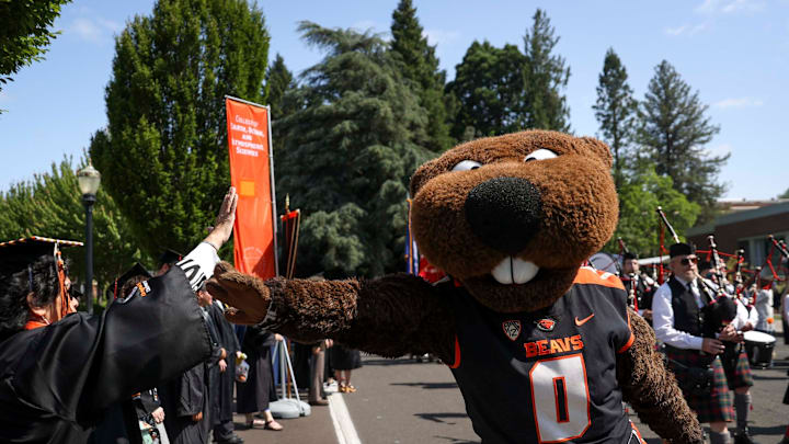 Benny Beaver high fives graduates during the processional of the Oregon State University 2025 commencement ceremony at Reser Stadium on Saturday, June 14, 2025 in Corvallis.