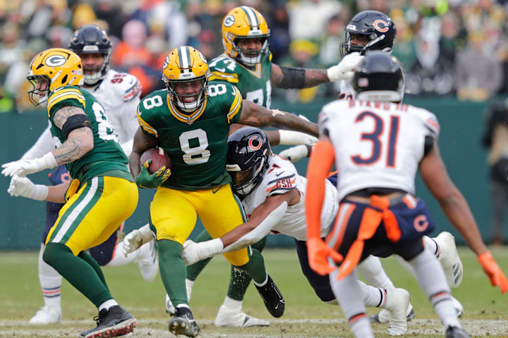 Green Bay Packers running back Josh Jacobs (8) runs for a first down against the Chicago Bears last year.