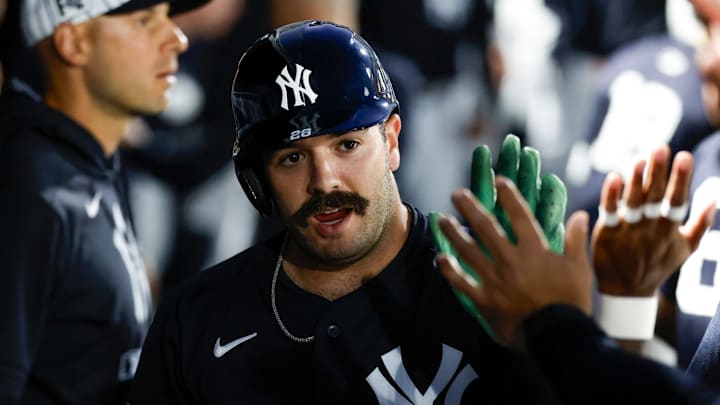 Austin Wells high-fives teammates in the New York Yankees dugout.