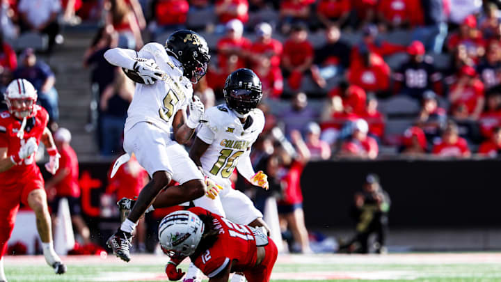 Oct 19, 2024; Tucson, Arizona, USA; Colorado Buffaloes wide receiver Jimmy Horn Jr. (5) jumps over Arizona Wildcats defensive back Genesis Smith (12) during the fourth quarter at Arizona Stadium. Mandatory Credit: Aryanna Frank-Imagn Images