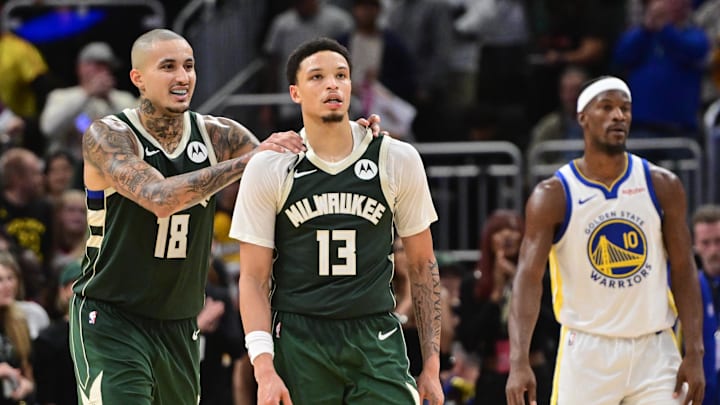 Oct 30, 2025; Milwaukee, Wisconsin, USA; Milwaukee Bucks guard Ryan Rollins (13) celebrates with forward Kyle Kuzma (18) after beating the Golden State Warriors as Warriors forward Jimmy Butler (10) looks on at Fiserv Forum. Mandatory Credit: Benny Sieu-Imagn Images