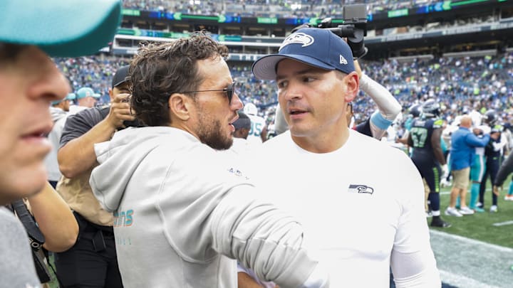 Sep 22, 2024; Seattle, Washington, USA; Miami Dolphins head coach Mike McDaniel, left, shakes hands with Seattle Seahawks head coach Mike Macdonald during the fourth quarter at Lumen Field. 