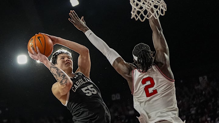Feb 28, 2026; Athens, Georgia, USA; South Carolina Gamecocks guard Mike Sharavjamts (55) goes to the basket against Georgia Bulldogs center Somto Cyril (2) during the second half at Stegeman Coliseum. Mandatory Credit: Dale Zanine-Imagn Images