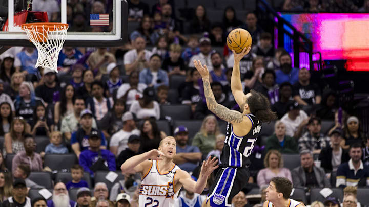 Apr 13, 2025; Sacramento, California, USA;  Sacramento Kings guard Devin Carter (22) shoots over Phoenix Suns center Mason Plumlee (22) during the fourth quarter at Golden 1 Center. Mandatory Credit: John Hefti-Imagn Images