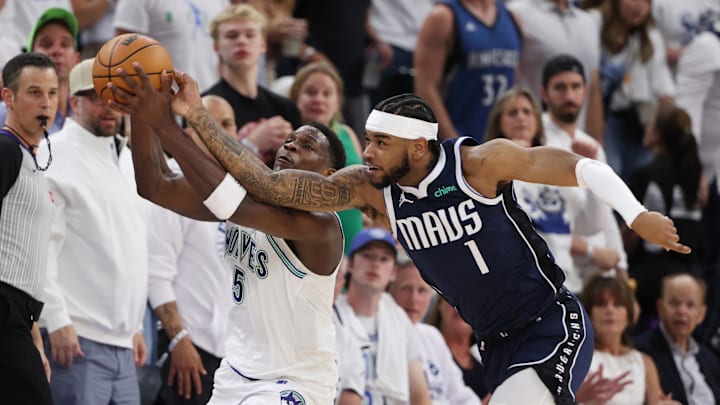 Minnesota Timberwolves guard Anthony Edwards (5) and Dallas Mavericks guard Jaden Hardy (1) fight for the ball in the first quarter during Game 1 of the Western Conference finals at Target Center in Minneapolis on May 22, 2024.
