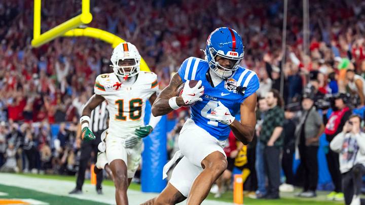 Jan 8, 2026; Glendale, AZ, USA; Mississippi Rebels tight end Caleb Odom (4) catches a two point conversion against the Miami Hurricanes during the 2026 Fiesta Bowl and semifinal game of the College Football Playoff at State Farm Stadium. Mandatory Credit: Mark J. Rebilas-Imagn Images