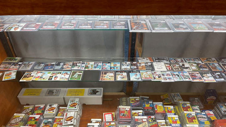 A showcase at my local card ship with singles, vintage packs and sets