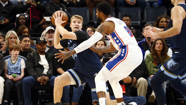 Nov 20, 2024; Memphis, Tennessee, USA; Memphis Grizzlies guard Cam Spencer (24) handles the ball as Philadelphia 76ers forward Paul George (8) defends during the first half at FedExForum. Mandatory Credit: Petre Thomas-Imagn Images